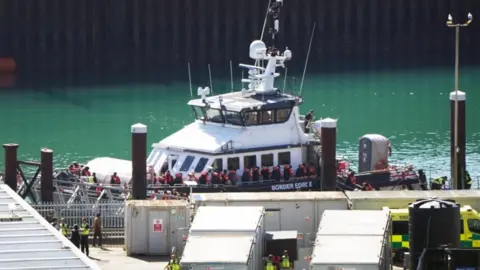 PA Media a Border Force boat with a crowd of people wearing life jackets