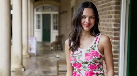 Josh Falcon/BBC Olivia Rodrigo poses outside The Old Kitchen of the 17th Century stately home, Kenwood House