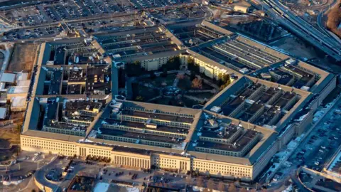 Getty Images An aerial image of the Pentagon building, showing an overhead view of the building and surrounding highways and trees.