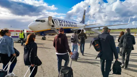 Getty Images Ryanair passengers boarding a B737 airplane at Malta International Airport, Luqa.