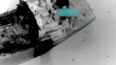 Centcom A screenshot from black and white surveillance footage shows a tanker in the sea. 