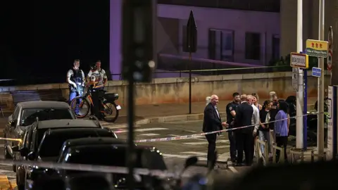 AFP via Getty Images Police near the scene of the blast late at night on a Monaco street