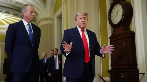 Getty Images Senate Majority Leader John Thune (L) and US President Donald Trump (R) speak to reporters at the Capitol.