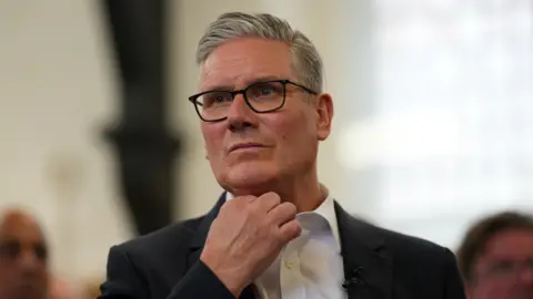 Getty Images Keir Starmer pictured wearing a white shirt and dark suit