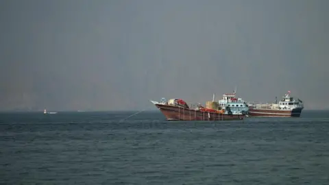 Reuters Two vessels at the Strait of Hormuz, taken from Musandam, Oman