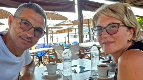 Facebook/Karovic Ljubisa Karovic Ljubisa and his wife Svetlana Grković, smiling for a photo in a bar which appears to be at a holiday resort 