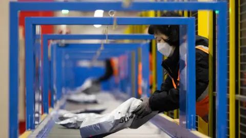 Getty Images An employee places a package on a conveyor at a Coupang Inc. fulfillment center in Daegu, South Korea, on Monday, Feb. 6, 2023. 