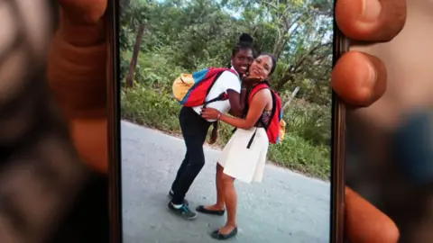 AndreÃna holds a phone with a picture of her and sister Ana Luz, Kleiber's mother, who is still missing