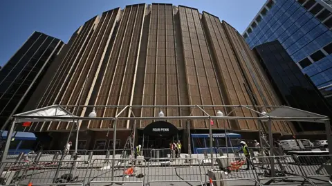 Getty Images Workers put up a tent frame outside Madison Square Garden.
