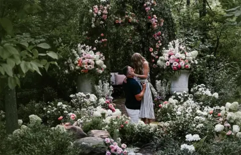 @TAYLORSWIFT Taylor Swift and Travis Kelce in a floral background