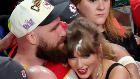 Reuters Travis Kelce and Taylor Swift hugging in a crowd