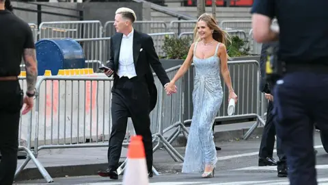 Getty Images US former football player Abby Wambach, left, and Glennon Doyle hold hands as they walk along the street next to barricades around Madison Square Garden. 