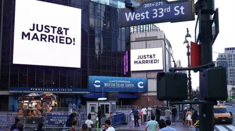 AFP via Getty Images A giant screen shows the message "JUST&T MARRIED!" (T&T for Taylor and Travis) outside Madison Square Garden, the reported venue for the wedding celebrations of pop singer Taylor Swift and pro-athlete Travis Kelce
