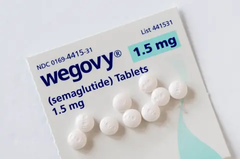 Universal Images Group via Getty Images Wegovy semaglutide tablets on a white background. Its a prescription medicine used with a reduced calorie diet and .and physical activity. 