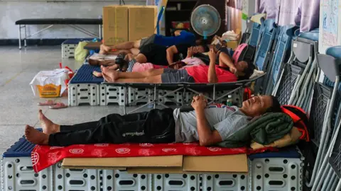 Getty Images People sleeping on makeshift beds in Taiwan