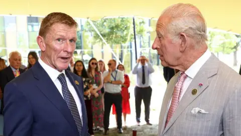 Reuters Tim Peake and King Charles stand next to each other talking. Both men are wearing suits