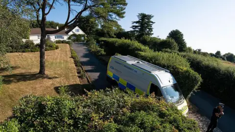 Getty Images A slightly aerial view showing the home of Ann Widdecombe. A police car is parked at the beginning of the drive with a police man standing on guard