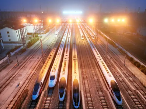 CFOTO/Future Publishing via Getty Images The high-speed trains are parked at the storage yard waiting to depart in Lianyungang City, Jiangsu Province, China in the early morning of June 30, 2026. 
