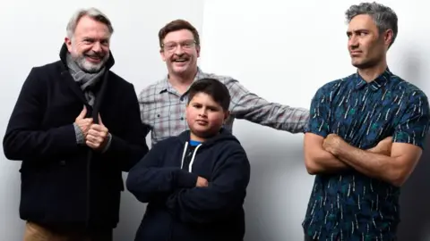 Getty Images  Actors Sam Neill, Rhys Darby, Julian Dennison and writer/director Taika Waititi from the film "Hunt for the Wilderpeople" pose for a portrait during the WireImage Portrait Studio hosted by Eddie Bauer at Village at The Lift on January 22, 2016 in Park City, Utah