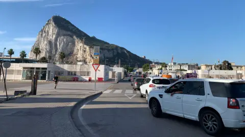 Cars queuing to get into Gibraltar from Spain, with the Rock of Gibraltar in the background