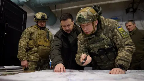 Ukrainian Presidential Press Service/Handout via Reuters Ukraine's President Volodymyr Zelenskiy listens to Commander of the Ground Forces colonel general Oleksandr Syrskyi as he visits a position of Ukrainian servicemen in 2023