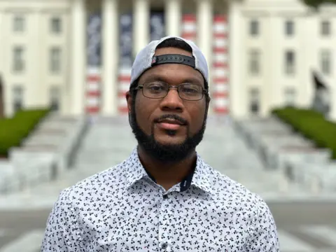 Brandon Drenon/BBC Cedric Coley stands for a portrait outside the Alabama state capitol building 