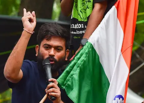 Getty Images Abhijeet Dipke addresses protesters as demonstrators take part in a protest organised by the Cockroach Janta Party (CJP) at Jantar Mantar during the opening day of Parliament's Monsoon Session on July 20, 2026 in New Delhi, India. 