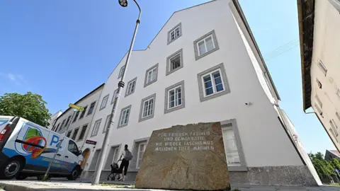 AFP via Getty Images A memorial stone stands in front of the birth house of former German dictator Adolf Hitler that is turned into a police station, in Braunau am Inn