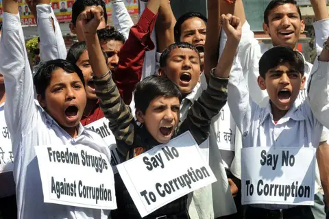 AFP via Getty Images 
Indian students shout anti-corruption slogans in support of veteran Indian social activist, Anna Hazare at a garden in Amritsar on April 8, 2011.