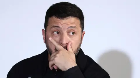 Pool/AFP via Getty Images Ukraine's President Volodymyr Zelensky takes part in a summit of the Coalition of the Willing to support Ukraine at the Hotel des Invalides in Paris on July 13, 2026.