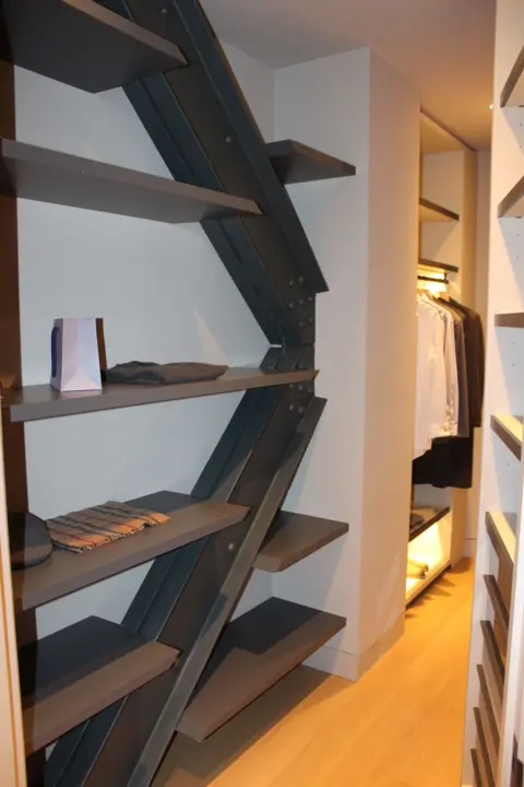 Grace Eliza Goodwin Zig-zagging steel beams with shelves built into them in a walk-in closet