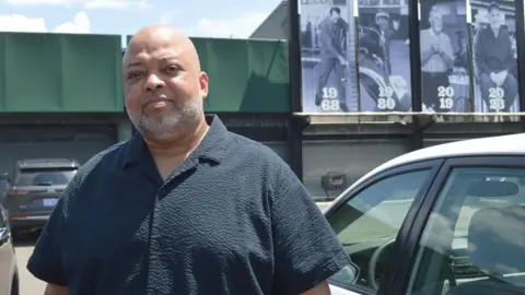 Cedric Erkins poses outside the grocery store