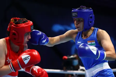 Getty Images  Oyuntsetseg Yesugen of Uzbekistan (red) in action against Jaismine of India in the Women's Feather (54-57kg)preliminary bout on Day Two of the Asian Boxing Championships on May 25, 2021 in Dubai, United Arab Emirates. (Photo by Francois Nel/Getty Images)