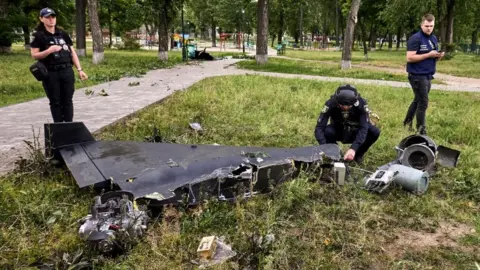 EPA-EFE/Shutterstock Ukrainian experts inspect drone debris after a strike on Kharkiv in the north-east of the country. Photo: June 2025