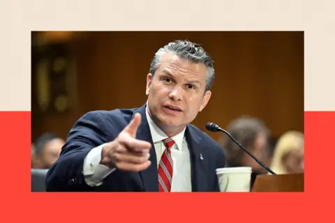 AFP via Getty Images Pete Hegseth gesticulates while talking during the Senate hearing. He is wearing a navy blue suit and a red and grey striped tie