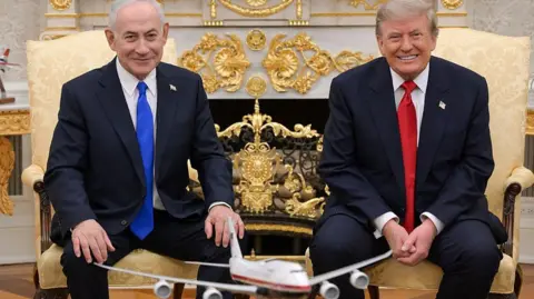 Maâayan Toaf (GPO)/Handout/Anadolu via Getty Images) Netanyahu and Trump smile towards the camera during their meeting at the White House