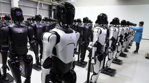 Getty Images An engineer debugs robots at the factory of AgiBot, a leading robotics company 