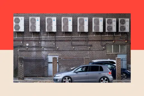 In Pictures via Getty Images Air conditioning units at the base of a building in Stratford 

