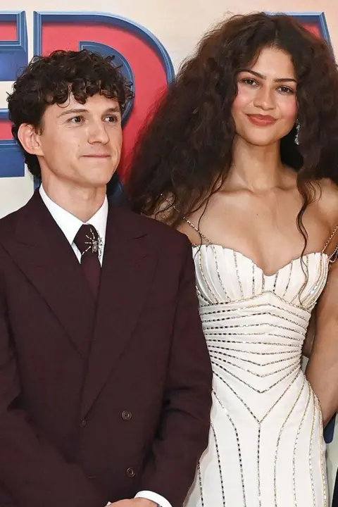 Getty Images A slightly closer, portrait picture of Tom Holland and Zendaya promoting Spider-Man: Brand New Day
