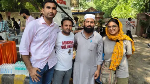 Mohammad Junaid Junaid poses with other protesters and volunteers at the Jantar Mantar protest site in Delhi