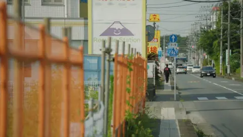 BBC Barriers are seen alongside a road where the mosque is being built