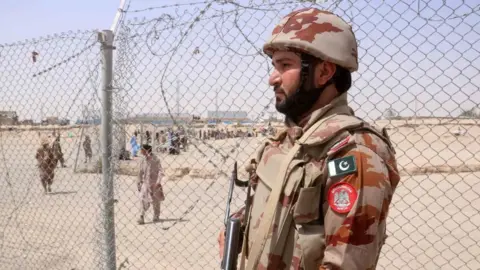 EPA A Pakistani security official stands guard at the Pakistan Afghan border in Chaman, Balochistan province.