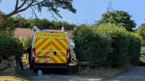 BBC A police van in the driveway of Ann Widdecombe's home on Dartmoor