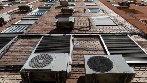 Getty Images Outdoor air conditioning units are pictured on a building