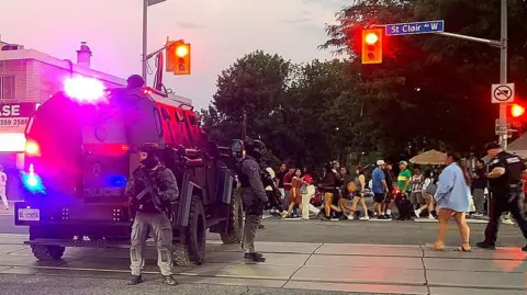 Getty Images Emergency Task Force vehicles and police officers are seen on the site of a shooting in Toronto, Canada on July 11, 2026.
