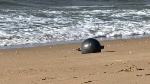 Queensland Fire Department One of the six mysterious large silver spheres washed up on Forrest Beach in Queensland.