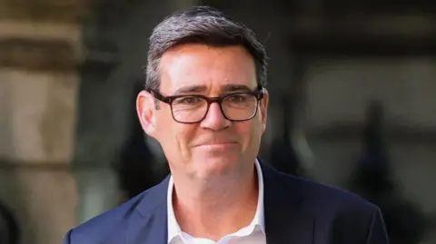 Reuters Andy Burnham pictured wearing a white shirt and dark suit