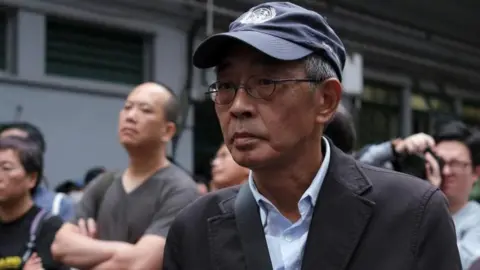 Reuters Bookseller Lam Wing-kee marches during a protest in Hong Kong to demand authorities scrap a proposed extradition bill with China. Photo: March 2019.