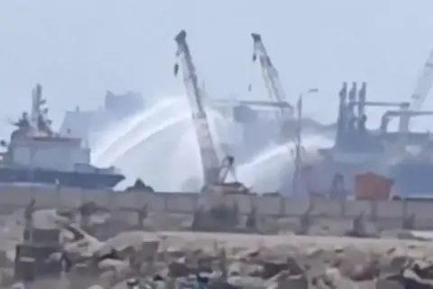 SOCIAL MEDIA/via REUTERS Social media video shows tugboats firing water jets at vessels on fire in Damietta port, Egypt (29 July 2026)