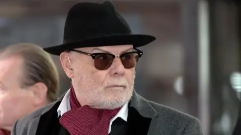 PA Media Gary Glitter pictured in 2015 wearing a trilby and sunglasses